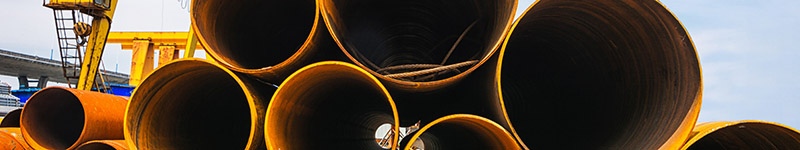 Pipes being stacked at a construction site.