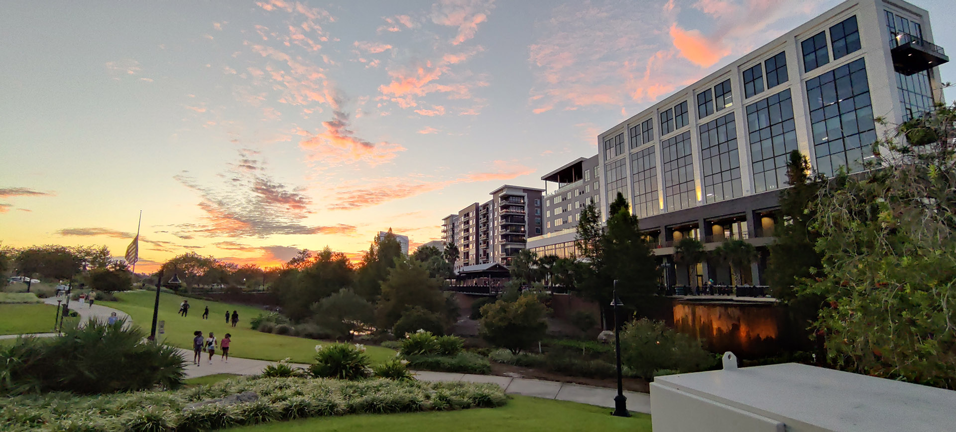 a panoramic photo of an event at cascades park at sundown.